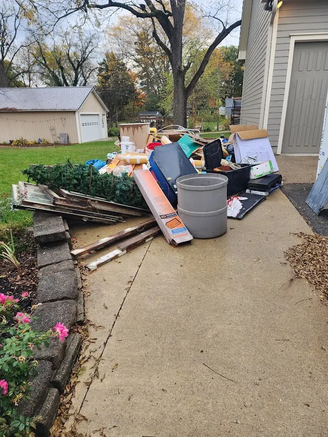 Dumpster being loaded with debris for 10 Yard Dumpster Rental in Topsfield